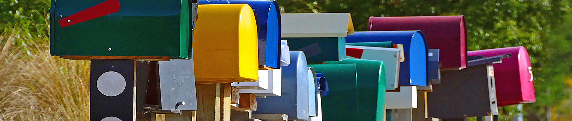 A row of mailboxes on the side of the road.