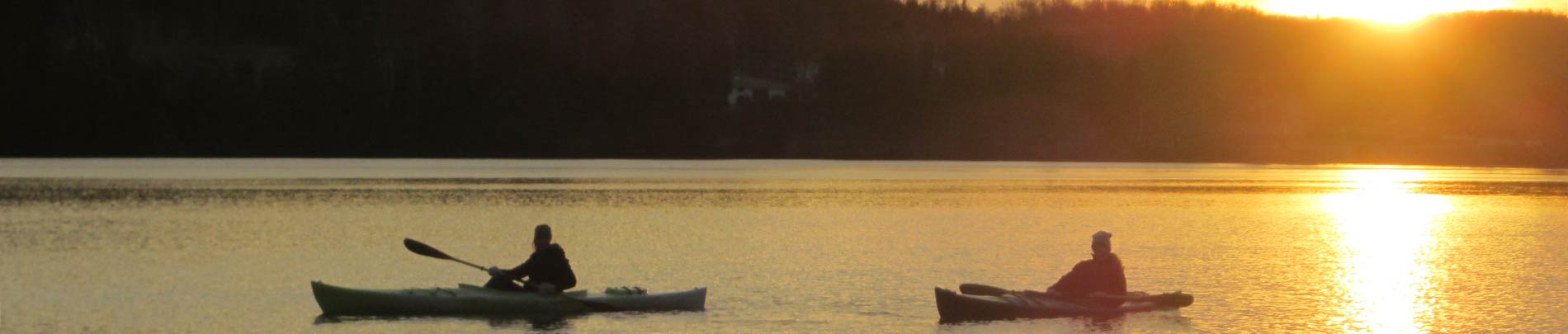 Canoes on Wilbermere Lake at sunset.