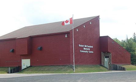 Canada flag flying in front of the Robert McCausland Memorial Community Centre in Gooderham.